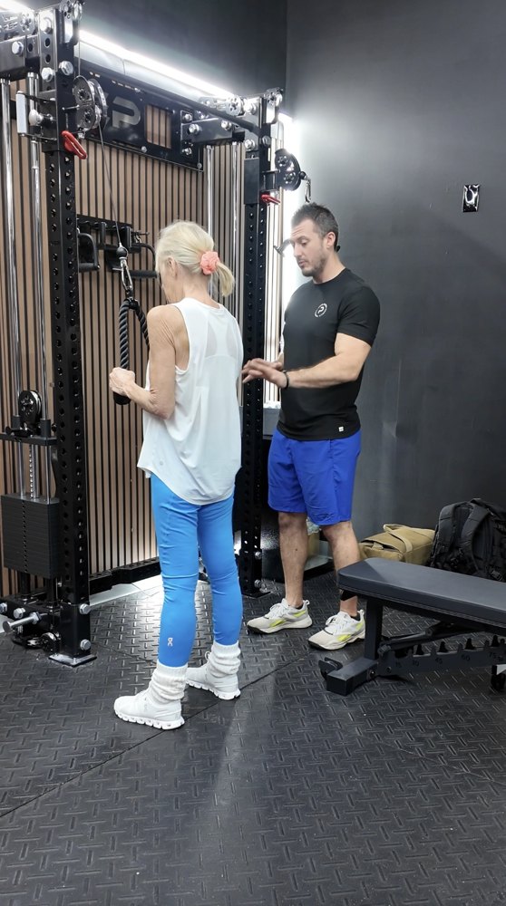 A Tradition Personal Fitness coach working one-on-one with a client