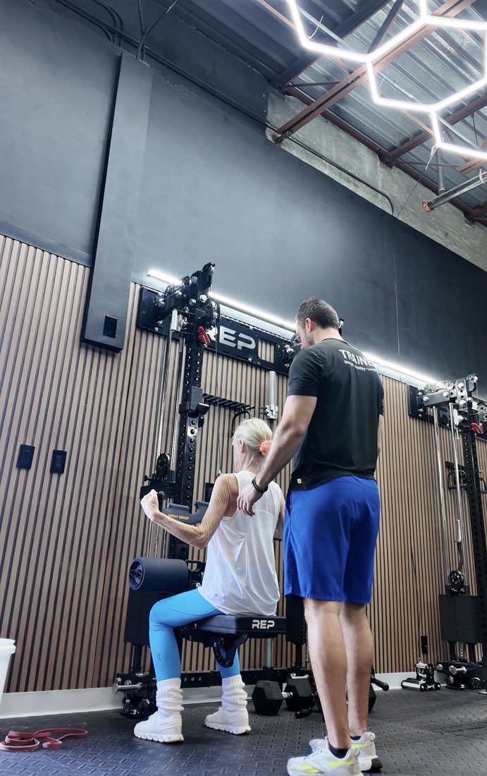 A Tradition Personal Fitness coach training an active-adult client